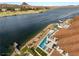Stunning aerial view of a lakeside property with a private pool and boat dock at 32 Grand Corniche Dr, Henderson, NV 89011