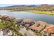 Breathtaking aerial view showcasing upscale homes along the water, surrounded by lush greenery and mountains at 32 Grand Corniche Dr, Henderson, NV 89011