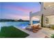 Outdoor patio with lounge chairs next to the lake and beautiful backyard at 32 Grand Corniche Dr, Henderson, NV 89011