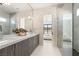 Luxurious bathroom with double vanity, elegant lighting, and a glass-enclosed shower for a spa-like experience at 32 Grand Corniche Dr, Henderson, NV 89011
