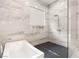 Bathroom with tub and marble tiled walk-in shower featuring glass door at 32 Grand Corniche Dr, Henderson, NV 89011