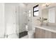 Modern bathroom with a glass-enclosed shower, floating vanity, and white tiled walls for a clean and bright space at 32 Grand Corniche Dr, Henderson, NV 89011