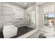 Modern bathroom featuring a soaking tub, glass shower, with a vanity in the background at 32 Grand Corniche Dr, Henderson, NV 89011