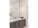 Modern bathroom featuring a large mirror and sleek vanity with white countertops and wood cabinetry at 32 Grand Corniche Dr, Henderson, NV 89011