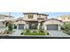 A stylish home with a three-car garage, gray brick accents, and a well-manicured lawn at 32 Grand Corniche Dr, Henderson, NV 89011