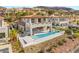 Elegant home showcasing a sleek infinity pool and an inviting patio with scenic views of the lake at 32 Grand Corniche Dr, Henderson, NV 89011