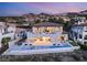A stunning two-story home features an infinity pool and outdoor seating, perfect for entertaining guests with mountain views at 32 Grand Corniche Dr, Henderson, NV 89011