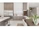 Modern kitchen with stainless steel appliances, custom cabinetry, and an open layout leading to the dining area at 32 Grand Corniche Dr, Henderson, NV 89011