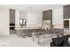 Modern, open kitchen with stainless steel appliances, large island and dining area at 32 Grand Corniche Dr, Henderson, NV 89011