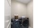 Efficient laundry room with modern washer and dryer set, providing convenience and functionality at 32 Grand Corniche Dr, Henderson, NV 89011