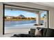 Spacious living room with sliding glass doors opening to the pool and lake views at 32 Grand Corniche Dr, Henderson, NV 89011