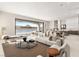 Spacious living room boasting scenic lake views, contemporary furnishings, and an open layout at 32 Grand Corniche Dr, Henderson, NV 89011