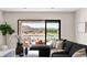 Elegant living room with stunning views of the lake and golf course, featuring comfortable seating at 32 Grand Corniche Dr, Henderson, NV 89011