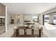 Bright, open-concept living room featuring a modern fireplace and seamless indoor-outdoor flow overlooking the water at 32 Grand Corniche Dr, Henderson, NV 89011