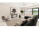 Stylish living room with modern furnishings, a glass coffee table, and panoramic views of the lake at 32 Grand Corniche Dr, Henderson, NV 89011