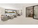 Open living room with modern design, a full lake view, and a seamless transition to outdoor spaces at 32 Grand Corniche Dr, Henderson, NV 89011