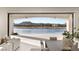 Bright living room with tiled floors, ceiling fans, and stunning lake view with access to the outside at 32 Grand Corniche Dr, Henderson, NV 89011