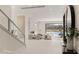 Spacious living room with lake views, fireplace, and glass-railed staircase for a modern feel at 32 Grand Corniche Dr, Henderson, NV 89011