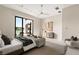 Serene primary bedroom with a view, featuring a comfortable seating area and elegant furnishings at 32 Grand Corniche Dr, Henderson, NV 89011