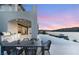Outdoor kitchen, dining area, and infinity pool with panoramic lake views at 32 Grand Corniche Dr, Henderson, NV 89011