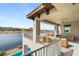 Chic patio space with a ceiling fan and an array of seating options overlooking the serene lake at 32 Grand Corniche Dr, Henderson, NV 89011