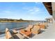 Stylish patio featuring plush seating arrangements overlooking the tranquil lake and scenic surroundings at 32 Grand Corniche Dr, Henderson, NV 89011