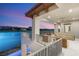Covered patio with lake view and seating areas, enhancing the home's luxury appeal at 32 Grand Corniche Dr, Henderson, NV 89011