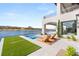 Modern outdoor pool and patio area with beautiful views of the lake and surrounding hills at 32 Grand Corniche Dr, Henderson, NV 89011