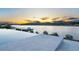 Tranquil infinity pool overlooking a serene lake at sunset with mountain views at 32 Grand Corniche Dr, Henderson, NV 89011