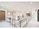 Open second-floor landing with glass railings, modern lighting, and bright, neutral decor at 32 Grand Corniche Dr, Henderson, NV 89011