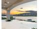 Covered patio with serene lake views and an infinity pool, perfect for relaxing at 32 Grand Corniche Dr, Henderson, NV 89011