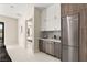 Convenient wet bar area with modern cabinetry, stainless steel appliances, and sleek countertops at 32 Grand Corniche Dr, Henderson, NV 89011