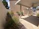 Backyard patio area with a covered ceiling, landscaping, and secure fencing at 3331 Cheltenham St, Las Vegas, NV 89129