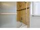 Bathroom featuring a shower with decorative tile accents and a glass door at 3331 Cheltenham St, Las Vegas, NV 89129