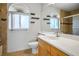 Bathroom with a shower, single sink vanity, updated mirror, and decorative shelving at 3331 Cheltenham St, Las Vegas, NV 89129