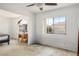 Bright bedroom with a ceiling fan and a large window letting in natural light at 3331 Cheltenham St, Las Vegas, NV 89129
