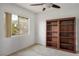 Neutral bedroom featuring a window overlooking trees and a large built-in bookcase at 3331 Cheltenham St, Las Vegas, NV 89129