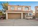 Charming two-story townhome featuring a two-car garage, tiled roof, and neutral stucco exterior at 3331 Cheltenham St, Las Vegas, NV 89129