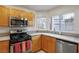 Bright kitchen features stainless steel appliances, light wood cabinets, and a view of the neighborhood at 3331 Cheltenham St, Las Vegas, NV 89129