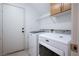 Laundry room featuring a full sized washing machine and dryer and built-in cabinetry at 3331 Cheltenham St, Las Vegas, NV 89129