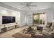 Bright living room featuring tile floors, a large sectional sofa, and sliding glass doors to the backyard at 3331 Cheltenham St, Las Vegas, NV 89129