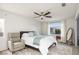 Primary bedroom with a ceiling fan, chair, and a large window for ample natural light at 3331 Cheltenham St, Las Vegas, NV 89129