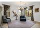 Inviting sitting room with elegant curtains, chandelier, and comfortable seating arrangement at 34 Contra Costa Pl, Henderson, NV 89052