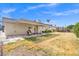Backyard featuring a covered patio area with a seating area and grassy space at 3492 Edison Ave, Las Vegas, NV 89121