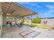 Covered patio features concrete flooring with brick trim and seating area at 3492 Edison Ave, Las Vegas, NV 89121