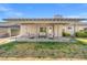 Outdoor covered patio with seating overlooking the grassy yard, perfect for entertaining at 3492 Edison Ave, Las Vegas, NV 89121