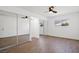 Large bedroom with hard wood flooring, closet with sliding mirrored doors, and windows at 3492 Edison Ave, Las Vegas, NV 89121