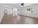 Spacious bedroom with wood floors, mirrored closet doors, and a bright window at 3492 Edison Ave, Las Vegas, NV 89121