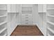 Walk-in closet featuring custom shelving, built-in drawers, and hardwood floors at 3492 Edison Ave, Las Vegas, NV 89121