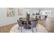 Charming dining room with hardwood floors, modern decor, and a view of the kitchen at 3492 Edison Ave, Las Vegas, NV 89121